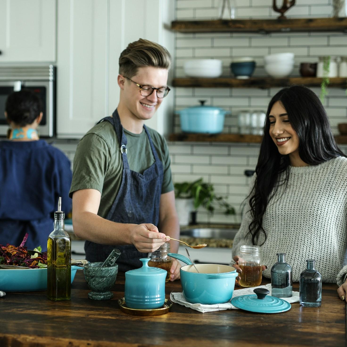 Community members collaborating in a modern kitchen space, sharing recipes and cooking techniques